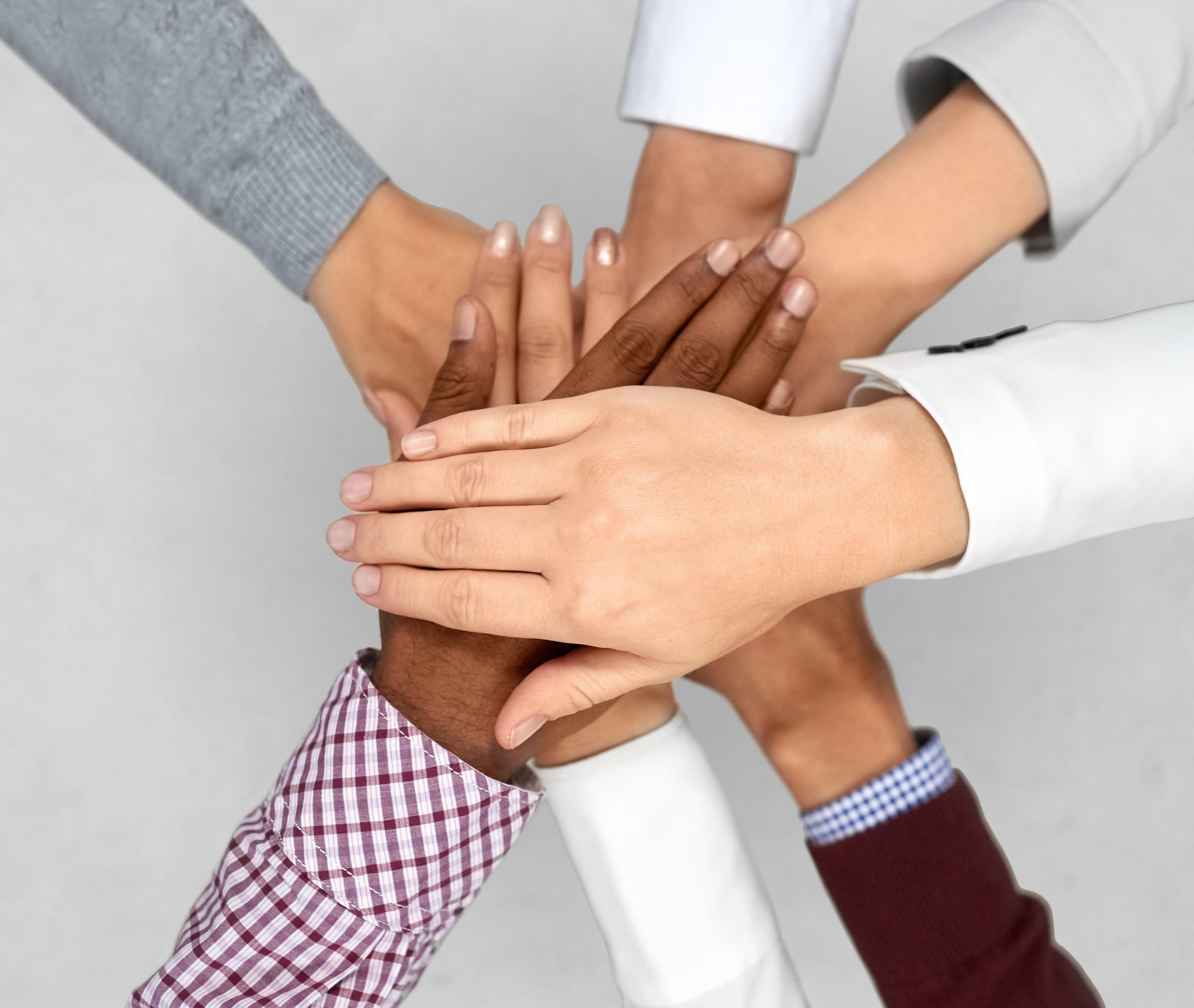 diverse business team putting hands together business startup and teamwork concept - diverse team putting their hands together