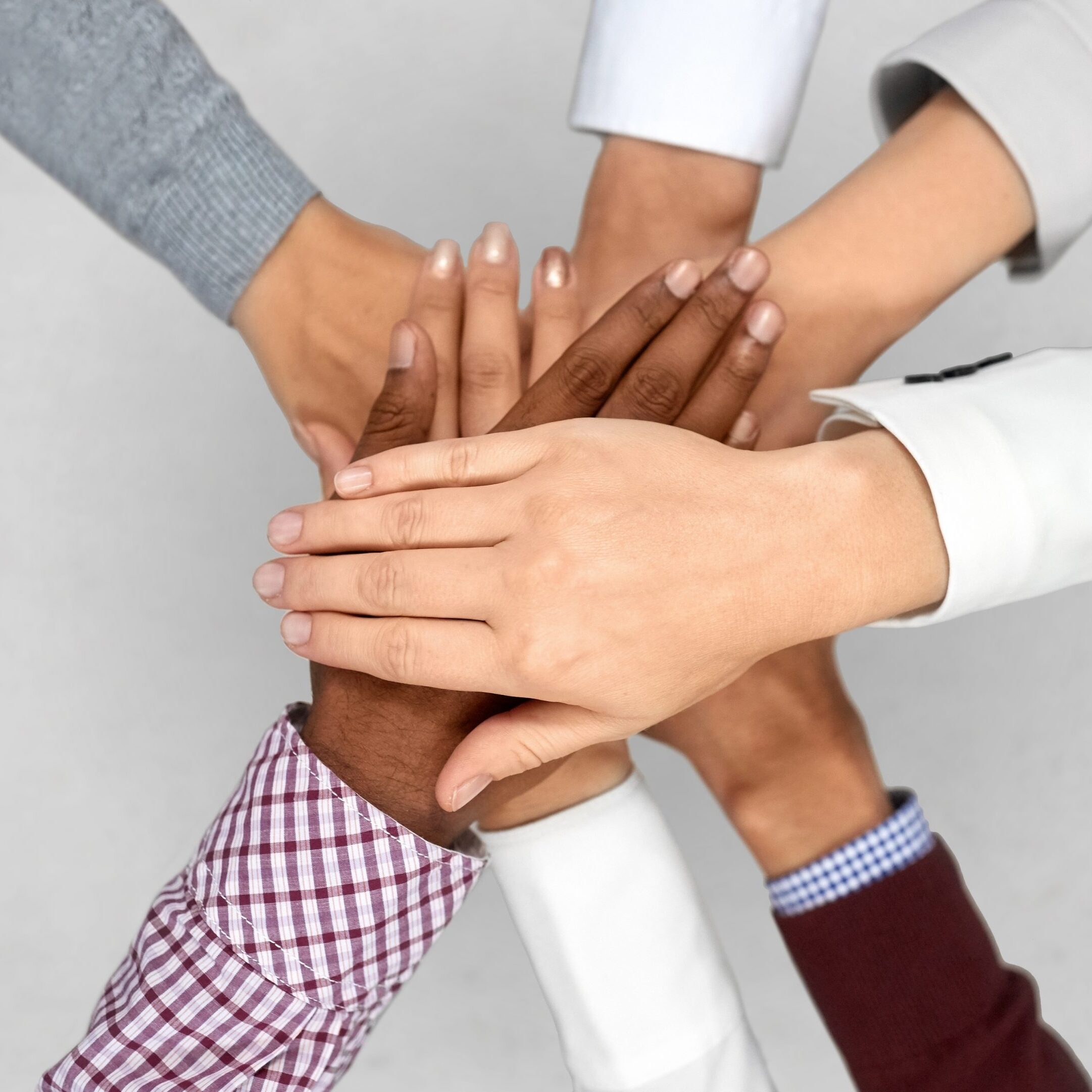 diverse business team putting hands together business startup and teamwork concept - diverse team putting their hands together